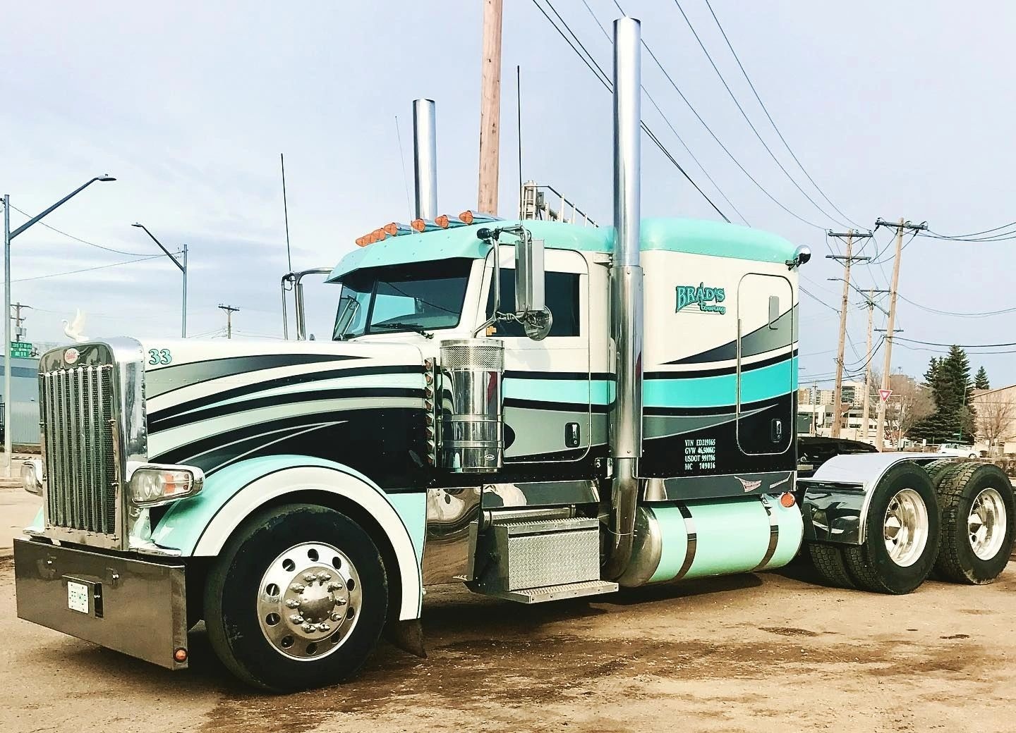 Aqua, black and silver custom decals on a Brad’s Towing semi truck