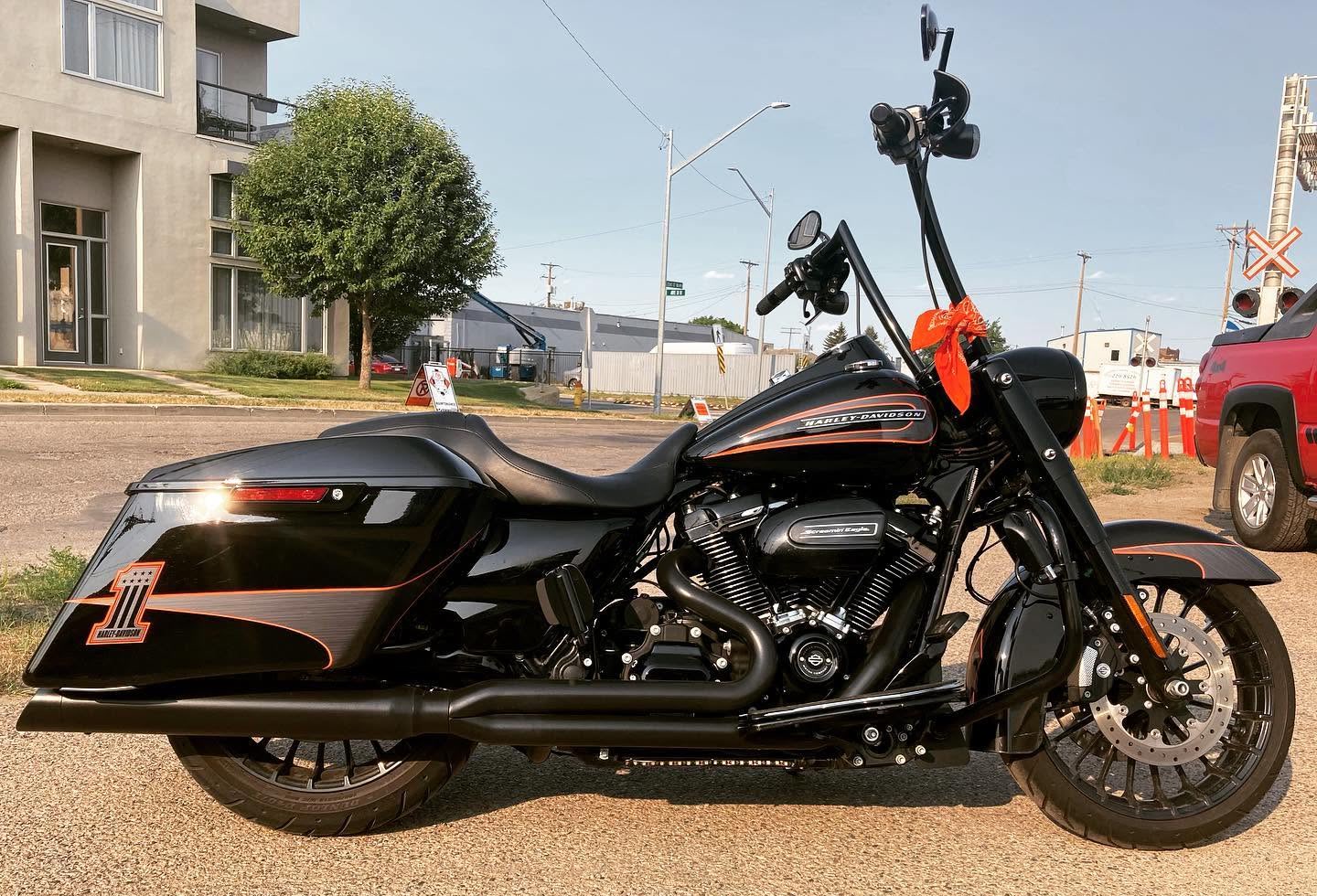 Black motorcycle with orange custom striping