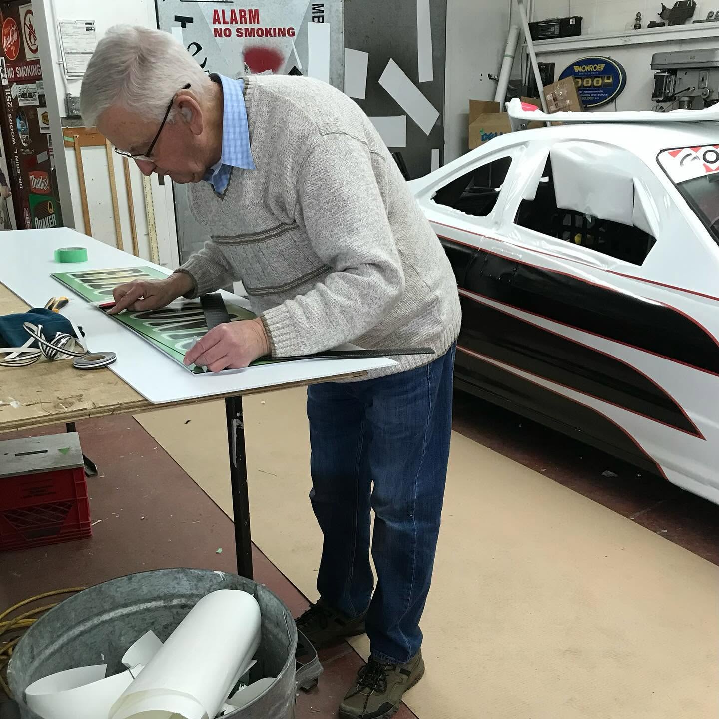 Sign lettering being carefully prepared by hand in the LB Signs workshop